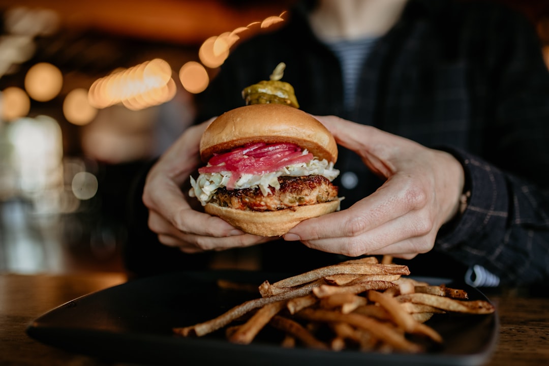 Burger with fries on a restaurant table, illustrating casual dining options